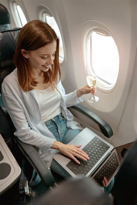 Joyful Woman Using Laptop And Drinking Champagne In Plane Stock Image Image Of Online