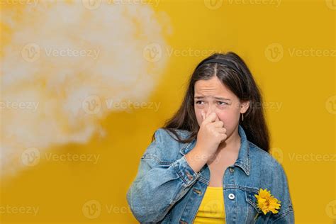 teen girl pinch her nose because toxic fumes from car bad smell air pollution dust allergies or