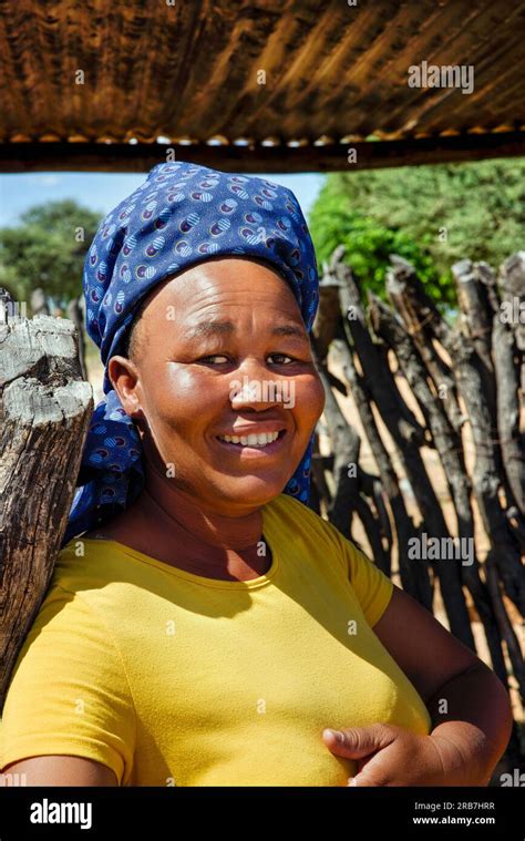 portrait of an african village woman standing in the yard outdoors kitchen in rural area stock