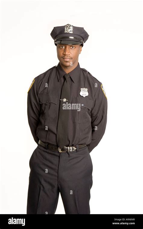 Young Black American Police Officer In Uniform Standing With His Hands