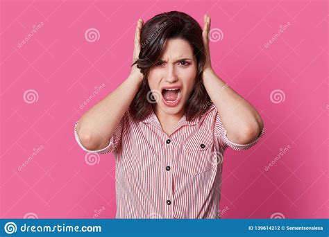 Frustrated Brunette Lady Yells With Anger Covers Ears Annoyed With