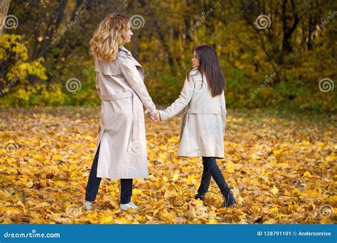 Happy Mother And Daughter Are Walking In The Autumn Park Stock Image Image Of October Couple
