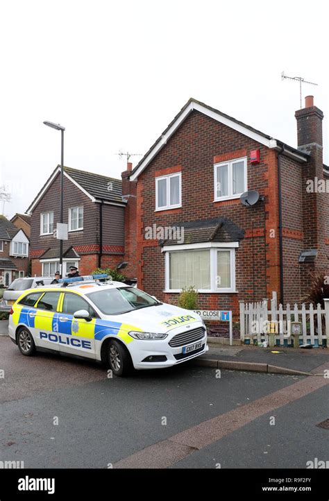 police outside the home in crawley west sussex of 47 year old man and 54 year old woman who