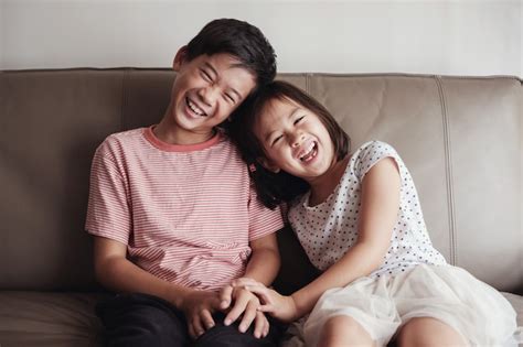 Premium Photo Laughing Asian Little Brother And Sister At Home