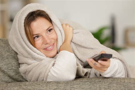 Woman Wrapped In Blanket Using Remote Control Stock Image Image Of