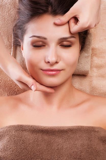 Premium Photo Eautiful Young Relaxed Woman Enjoy Receiving Face Massage At Spa Saloon