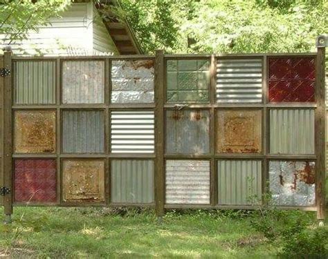 A Fence Made Out Of Old Windows In The Grass With Trees And Bushes