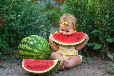 Premium Photo The Child Eats Watermelon In The Summer Selective