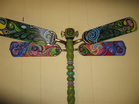 A Colorful Dragonfly Sculpture Is Hanging On The Wall