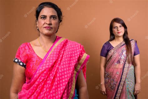 premium photo two mature indian women wearing sari indian traditional clothes together