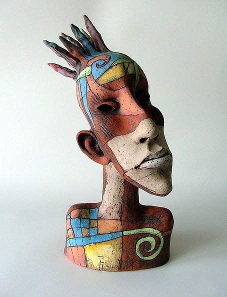 A Ceramic Sculpture Of A Woman S Head With Different Colors And