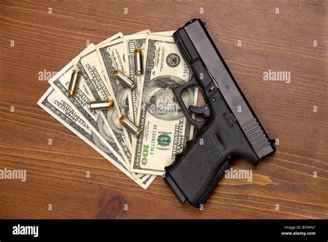 Bullets Cash And A Gun On A Table Stock Photo Alamy