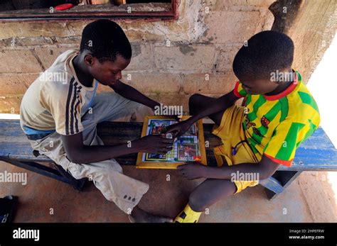 Burkinabe Boys Playing A Football Related Board Game Stock Photo Alamy