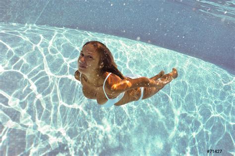 Girl Swimming Underwater With White Bikini In Swimming Pool Stock