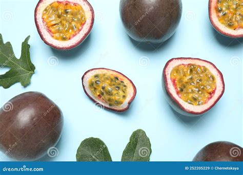 Fresh Ripe Passion Fruits Maracuyas With Green Leaves On Light Blue Background Flat Lay Stock