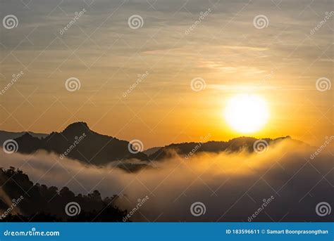 Sunrise And Morning Light Behind The Mountains With The Mist Covered