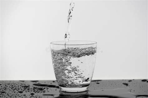 Motion Blur Of Pouring Pure Drinking Water Flow Into The Glass Making