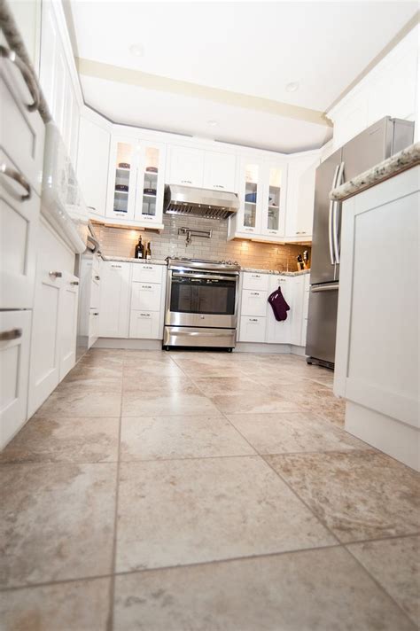 Hardwood floors work, cork works, and bamboo works too but when it comes to certain rooms of the house tile is an even better way to go. Beautiful tan tile floors to match the all white cabinets ...