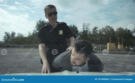 policeman arresting criminal on parking lot stock footage video of defense criminal 101989868