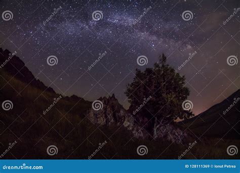 Milky Way Galaxy Constellation Seen In The Dark Near A Sharp Rock And A