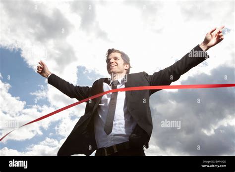 Businessman Crossing Finish Line Stock Photo Alamy