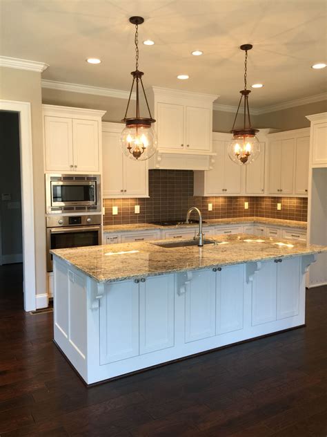 In my opinion, this beige wall paint goes well with white especially the very basic shade of white, which is often called by bright white, clean white, or pure white. Sherwin Williams Pure White Cabinets. Worldly Gray Walls. White ice granite, dark gray s ...