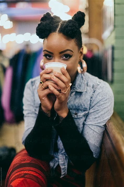 A Woman Drinks A Coffee In A Cafè And Looks At The Camera By Stocksy