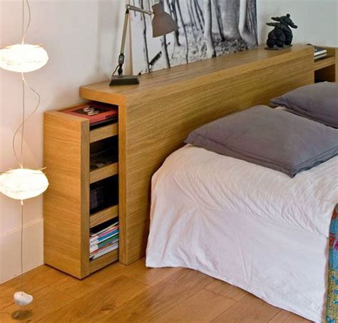 A Bed Sitting In A Bedroom Next To A Night Stand With Two Lamps On Top