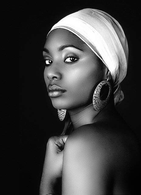 A Black And White Photo Of A Woman In A Turban With Earrings On Her Head