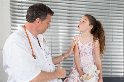 Doctor Giving Checkup To Young Girl In Exam Room 961766 Stock Photo At