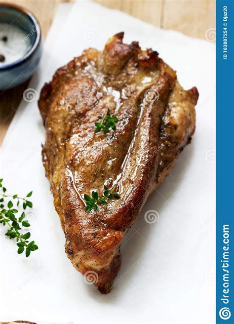 A boneless picnic shoulder often weighs between 5 to 8 pounds and may come in netting to keep it together. Baked Pork Shoulder On The Bone With Spices, Herbs And Aromatic Oil Stock Photo - Image of bowl ...
