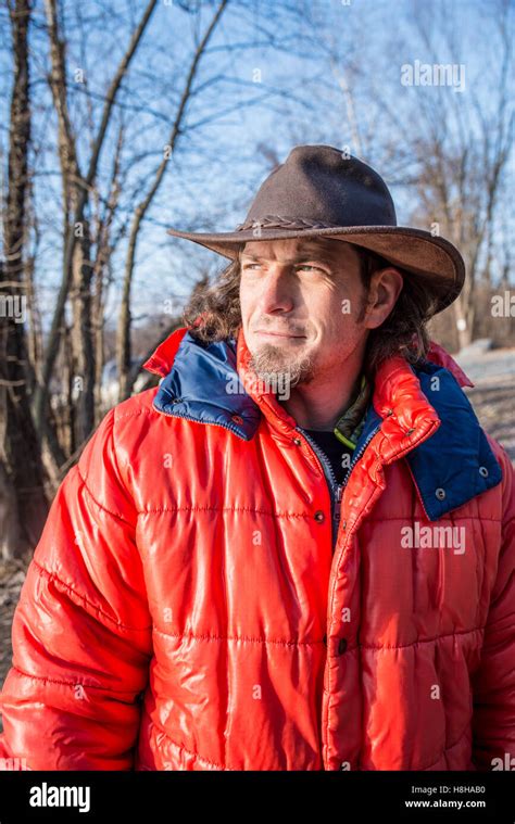 Outdoorsman Wearing Orange Parka In Winter Adventure Stock Photo Alamy