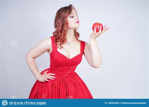 Young Pin Up Girl Holding Red Apple In Her Hand Stock