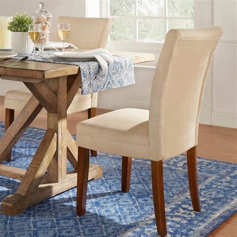 Our gallery contains upholstered dining chairs in a refreshing range of colors, styles, and materials, the better to showcase the astounding number sleek minimalism informs the bright look of this dining room, centered on a dark wood table surrounded with soft beige toned upholstered parson chairs. Parson Classic Upholstered Dining Chair (Set of 2) by ...