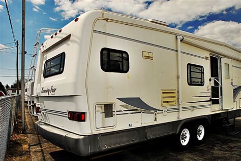 Dual slides, awning, sleeps 4, a/c unit, leveling jacks.this american start 5th wheel by newmar has set the bar in luxury fifth wheels. Pre-Owned 1998 Newmar Kountry Star 33RKWD Fifth Wheel
