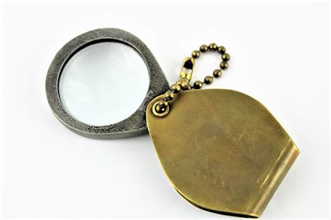1915 military issue folding magnifying glass in a brass travel case