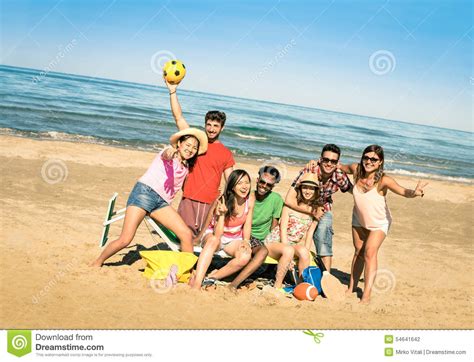 Group Of Multiracial Friend Couples Having Fun Time Out At Park Stock