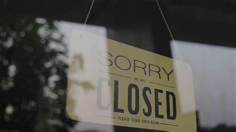 Closed Sign Hanging On The Door Front Of A Shop Stock Video Footage