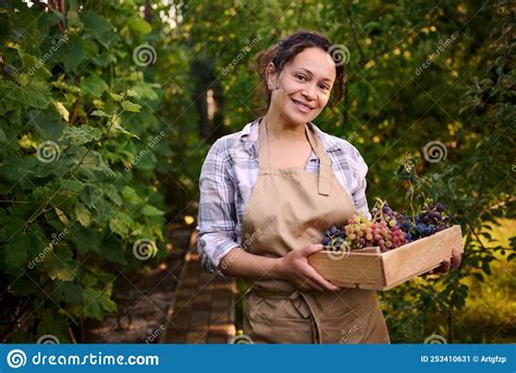 Smiling Young Woman Vine Grower Vintner Viticulturist Holding A