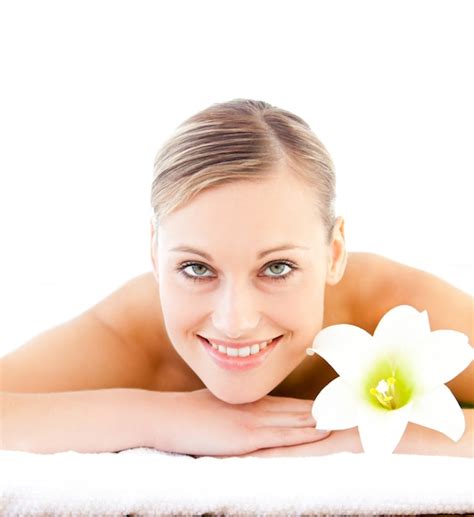 Premium Photo Close Up Of A Positive Woman Lying On A Massage Table With A Flower