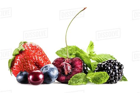 Composition Of Assorted Berries And Mint Leaves Isolated On White