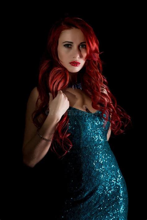 Beautiful Redhead Woman With Big Tits In A Tight Dress Posing On A Dark