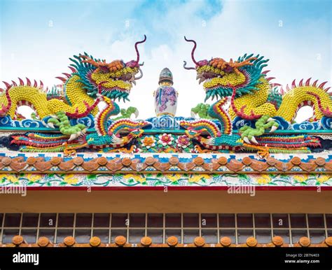 Colorful Twin Chinese Dragon Statues Adorned The Rooftops Of Pavilions