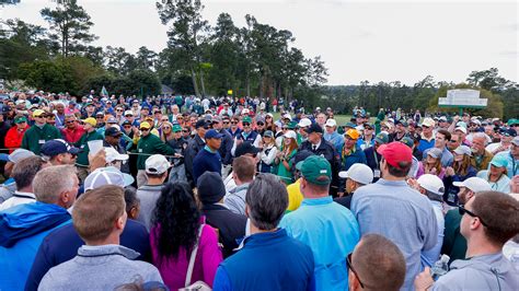 masters patrons applaud as masters champion tiger woods walks to the no 1 tee during the second