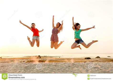 Smiling Teen Girls Jumping On Beach Stock Image Image