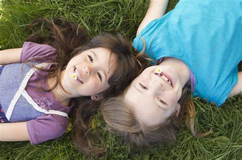 Smiling Girls Laying In Grass Together Stock Image F0057457