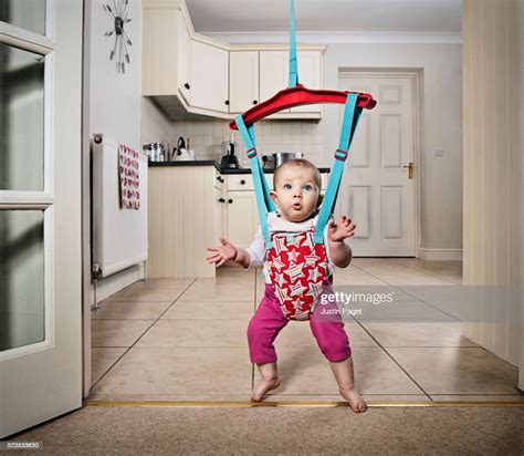 Baby Girl Dancing In Door Bouncer High Res Stock Photo Getty Images