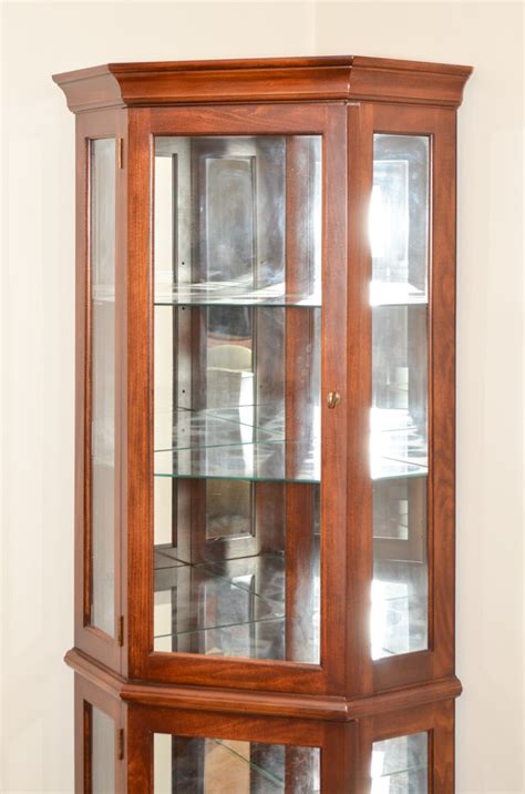 The other benefits of having a corner cabinet as storage is: Contemporary Lighted Corner Curio Cabinet | EBTH