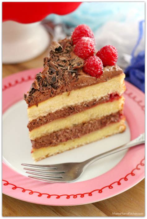 With a brownie layer on the bottom and a decorative jaconde sponge wrapped around the decadent layers, this is a true showstopper dessert! Raspberry Chocolate Mousse Cake | Mama Harris' Kitchen