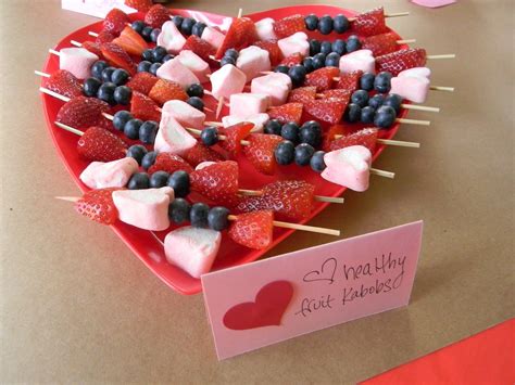 A Heart Shaped Platter Filled With Fruit And Marshmallows For Valentine